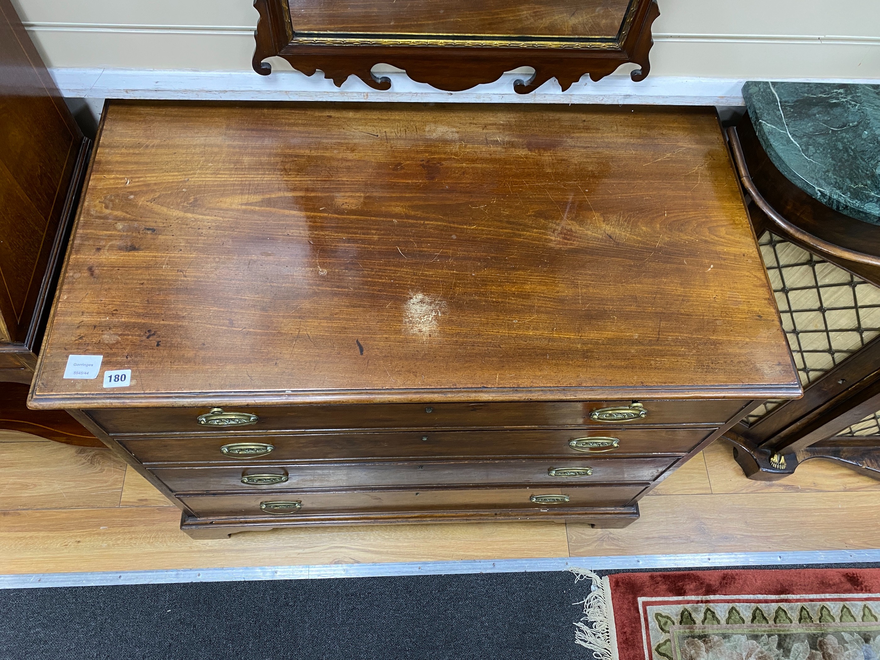 A George III mahogany chest, fitted four long graduated drawers, and brushing slide, width 98cm, depth 52cm, height 79cm